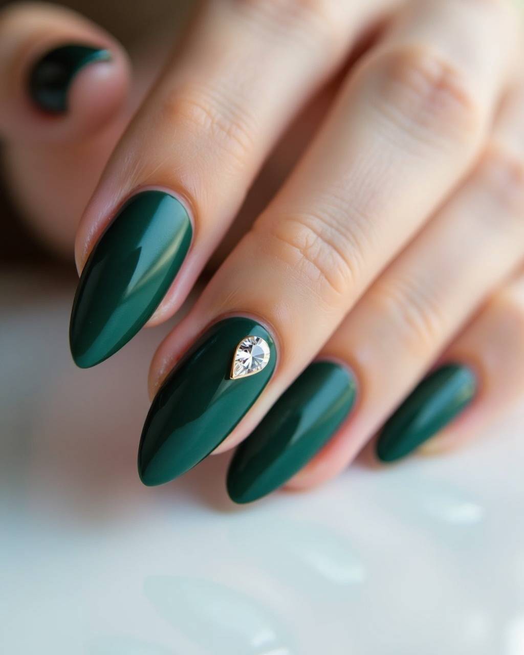 Almond rhinestone nail design by Noor Haddad