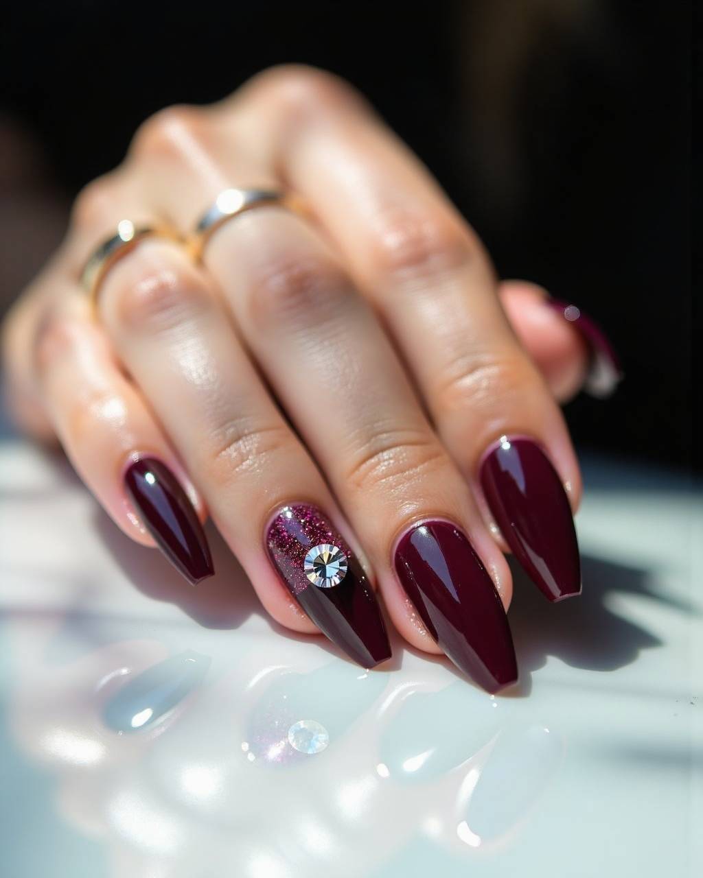 Stiletto rhinestone nail design by Noor Haddad